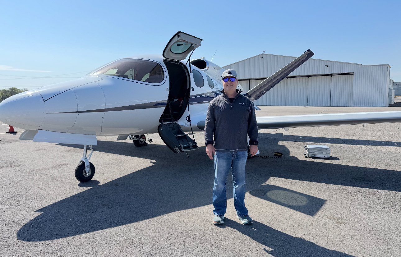 Jay Hirshberg beside his Cirrus Vision Jet on the ramp